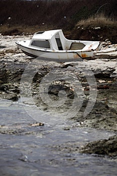 Fishing boat beached on a rock