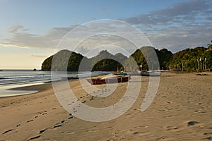 Fishing boat on the beautiful sandy coast of the negros island in the philippines in asia photo