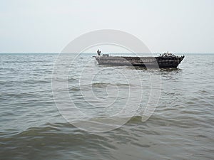 Fishing boat in blue sea with clouds sky background in Thailand.