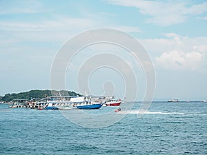 Fishing boat in blue sea with clouds sky background in Thailand.