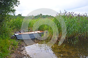 Fishing boat in a calm lake water.