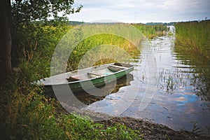 Fishing boat in a calm lake water.