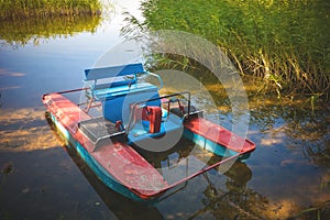 Fishing boat in a calm lake water.