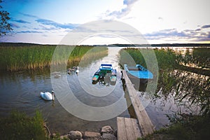 Fishing boat in a calm lake water.