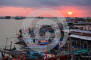 Fishing boat and cargo ship at sunrise in Cha-Am