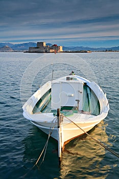 Fishing boat and a castle, Nafplio, Greece.