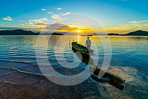 Fishing boat with child boy on sunset at Bang phra reservoir ,sriracha chon buri,  thailand