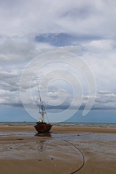 Fishing boat in the cloundy sea