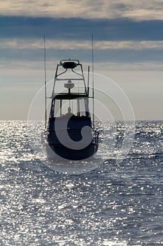 Fishing boat coming back into harbor after a day of fishing.