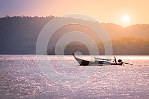 Fishing boat cruising on the sea at sunrise time