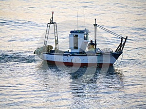 Fishing boat at dawn off the beach in Fuengirola Spain