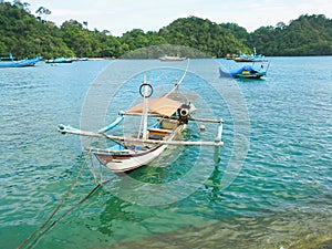 A fishing boat is docked at Sendangbiru beach