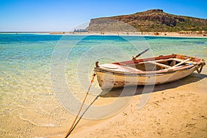 Fishing boat docked to coast on the beach of Crete, Greece