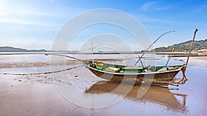 Fishing boat docking on the sand bars in morning sunrise