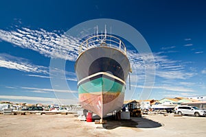 Fishing boat in dry dock, low angle photo with blue sky in Oleron Island, France