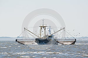 Fishing boat on Dutch wadden sea photo