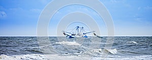 Fishing boat fishing in rough seas