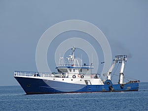 Fishing boat floating on a sea.