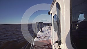 Fishing boat floats in the sea at sunset. Clip. View from the barge to the sea horizon. Romantic swim at dawn in the sea