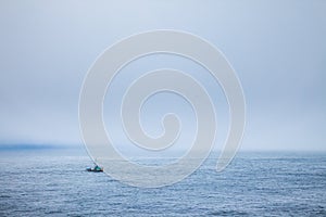 A fishing boat in the fog just off the coast of Cape Flattery, Washington