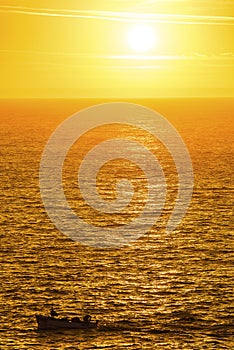 Fishing boat on a golden ocean