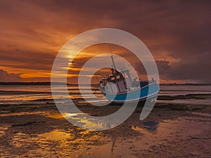 Fishing Boat grounded at low tide in Poole Harbour