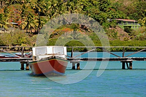 Fishing boat that has been hired for the day, moored near the dock for an hour of snorkeling,RakiRaki Island,Fiji,2015