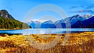 Fishing Boat heading up Pitt Lake with the Peaks of the Golden Ears, Tingle Peak and other Peaks in the Coast Mountain