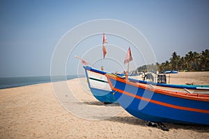 Fishing boat of Indian fishermen on the sandy beach in Kerala, fishing village Mararikulam.