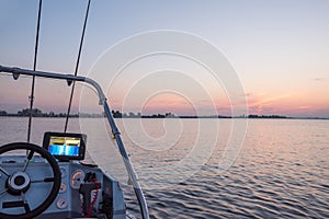 A fishing boat with instruments and an echosounder at dawn on the water. photo