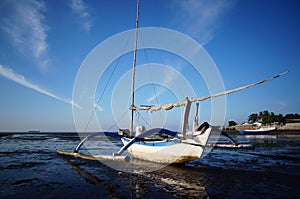 Fishing boat leaning against the pier