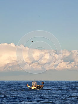 Fishing boat in the middle of the sea on a winter afternoon