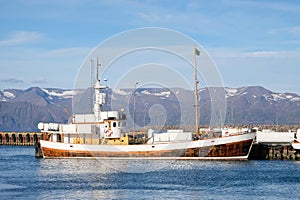 Fishing boat moored in the bay against the backdrop of mountains