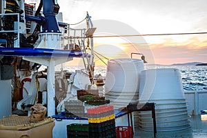 Fishing boat moored or docked at pier in sunset