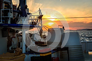 Fishing boat moored or docked at pier in sunset