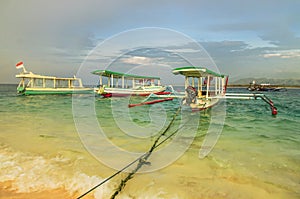 The fishing boat is moored on the sandy beach of Gili Meno island. Indonesia