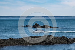 Fishing Boat navigating Maine`s rough coastline