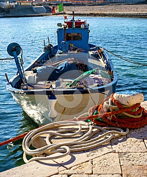 Fishing boat near the pier moored harbor