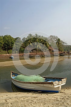 Parked fishing boat on the water age of Nivati India photo