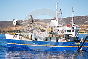 Fishing boat, ocean and offshore with a commercial and fisherman transportation on water. Ship, harbor and nature with