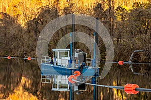 Fishing Boat park in a lake with fall season background