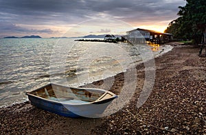 Fishing boat parked in the beach at sunset time in Thailand