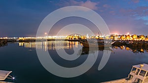 Fishing boat parked near the fish market next to Kuwait City Area day to night timelapse