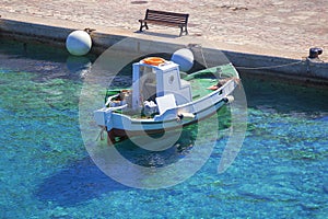 Fishing boat in port with reflections dock