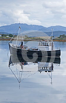 Fishing boat reflected in the water