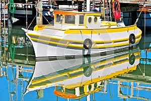 Fishing boat reflected in the water in San Francisco, USA.