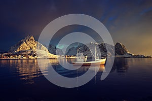 fishing boat and Reine Village, Lofoten Islands