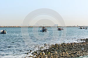 Fishing boat sailing at the sea in the corniche park, the city of Dammam, Kingdom of Saudi Arabia