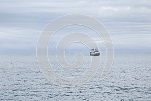 Fishing boat at sea on a cloudy morning