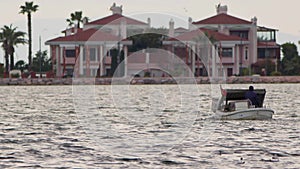 Fishing Boat in the Sea and Houses